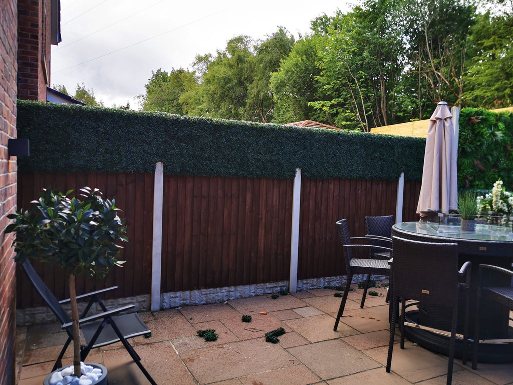 artificial hedge extension on wooden fence