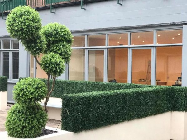 A maintenance free courtyard with artificial hedges